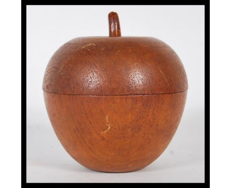 A 20th century turned / treen fruitwood tea caddy in the form of an apple, the apple in two parts being lead lined.Measures 1