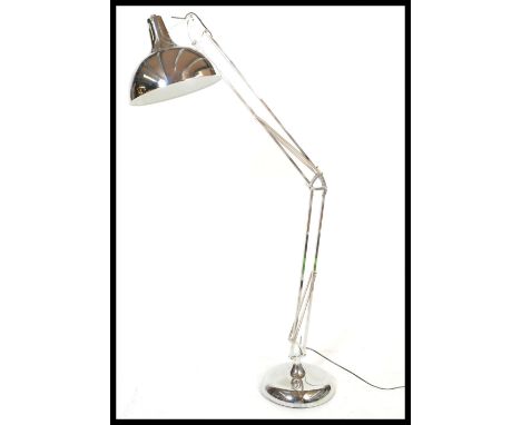 A large retro style floor standing chrome anglepoise lamp, raised on a large circular base with adjustable sprung uprights te