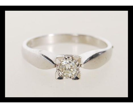 A hallmarked 9ct white gold solitaire ring illusion set with a brilliant cut diamond. Hallmarked Sheffield 1000. Estimated di