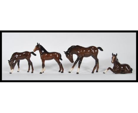 A group of four Royal Doulton ceramic figurines modelled as horses / fouls in various positions / poses, each with Royal Doul