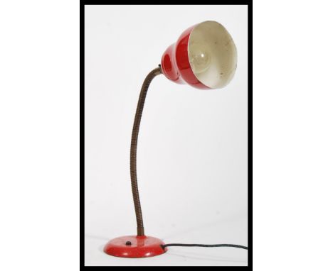 A vintage retro 20th Century industrial desk lamp raised on circular base with adjustable gooseneck and red enamel pendant sh