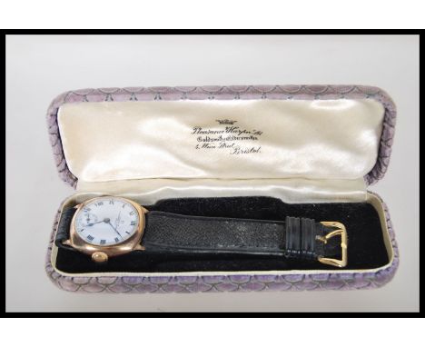 A 20th Century 9ct gold Omega wrist watch, having a white enamel face with bold numeral chapter ring, faceted hands and subsi