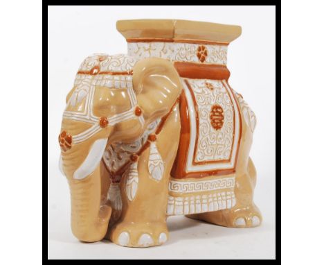 A decorative 20th Century stone / ceramic garden seat in the form of an elephant, decorated in neutral colours.