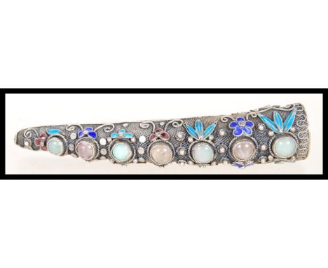 A early 20th Century marked silver finger claw/ ring, having filigree decoration and cabochon jade and crystal stones to top,