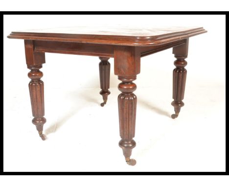 A 19th century Victorian mahogany extendable dining table, raised on fluted baluster legs terminating on ceramic castors.&nbs
