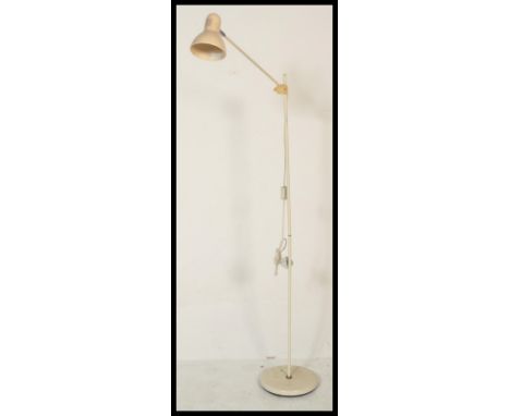 A vintage 20th Century industrial Herbert Terry style floorstanding anglepoise standard sppt lamp, raised on a circular base 
