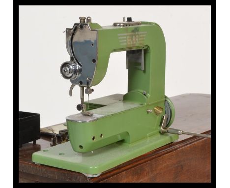A vintage mid 20th Century circa 1950's Elna Type 500970 sewing machine,110/120V SWISS Grasshopper, having original manual / 