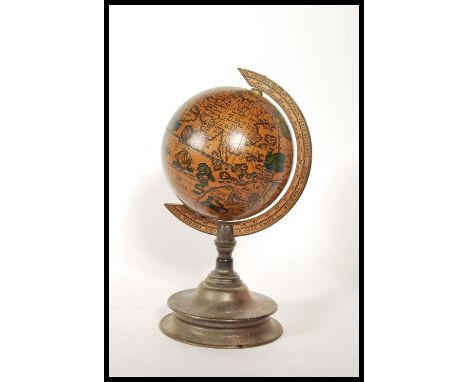 A 20th Century Georgian revival Italian style desktop terrestrial globe raised on a turned fruitwood base.