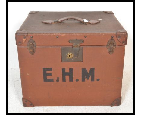 A large&nbsp; early 20th Century canvas and leather bound hat box / steamer trunk, the hinged top with leather carrying handl