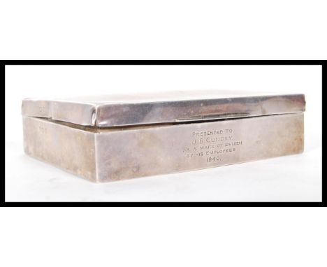 A silver hallmarked cigarette box having engine turned decoration to the lid and engraved initials to the corner, pine lined 