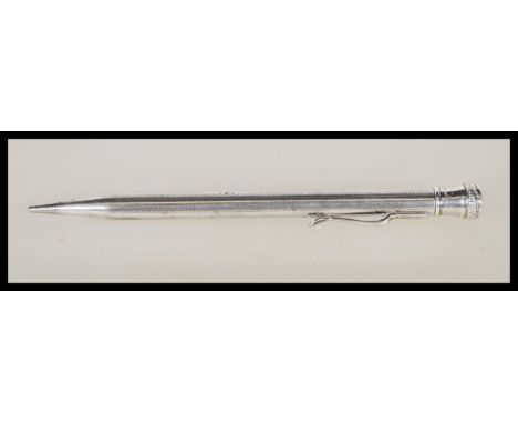 A 20th Century stamped sterling silver propelling pencil having engine turned decoration and finial top marked 'Life Long'. W