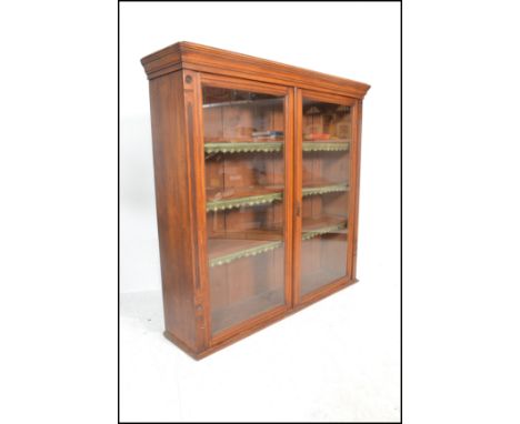 A Victorian large mahogany library bookcase cabinet having twin full length glazed panel doors housing adjustable shelves set