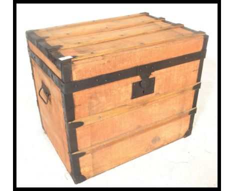 An early 20th Century pine iron bound trunk coffer chest box of square form having wrought iron drop handles to the side.&nbs