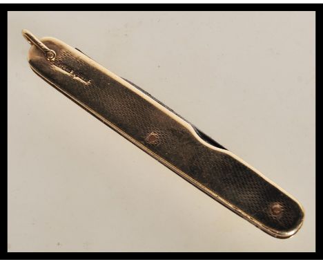 A 1920's 9ct gold cased penknife with engine turned decoration, having two folding blades within. Hallmarked London 1927 by&n