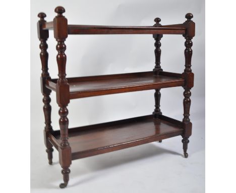 A Victorian 19th century mahogany 3 tier buffet sideboard. Raised on turned legs united by gallery edge tiers having turned c