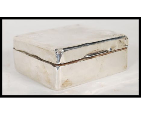 An early 20th Century Mappin &amp; Webb silver hallmarked cigarette box having engine turned decoration to the top with engra