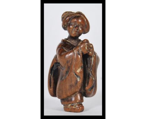 A 19th Century Japanese Meiji period carved netsuke depicting a Geisha lady, signed character marks to verso.Measures 5cm hig