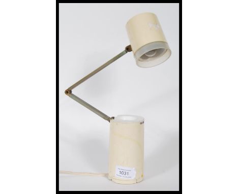 A vintage industrial Lloyds high intensity lamp model NA-101 constructed from a cream tubular body with a posable anglepoise 