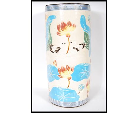 A 20th Century 1930's Art Deco Oriental ceramic cylindrical stick stand having lotus flowers, blue water lilies and swans thr