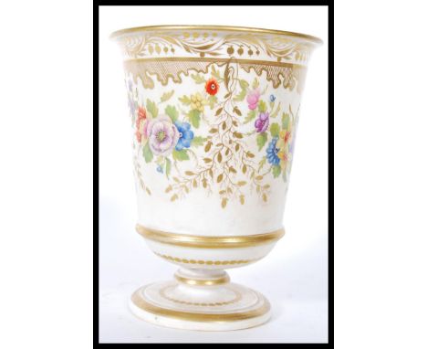 A 19th Century French Sevres ceramic goblet having hand painted floral sprays coloured in pinks and yellows with gilt detaili