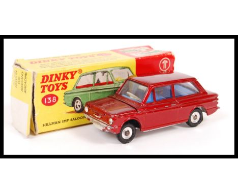 An original vintage 1950's Dinky Toys made diecast model car 138 Hillman Imp Saloon in original box. Red paint finish with bl