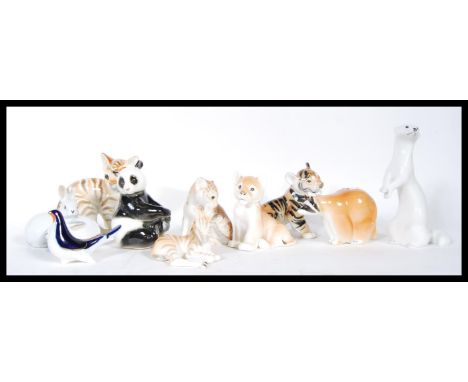 A collection of eleven vintage Russian USSR&nbsp;Lomonosov ceramic figurines of animals to include tiger cub, zebra, corgi, l