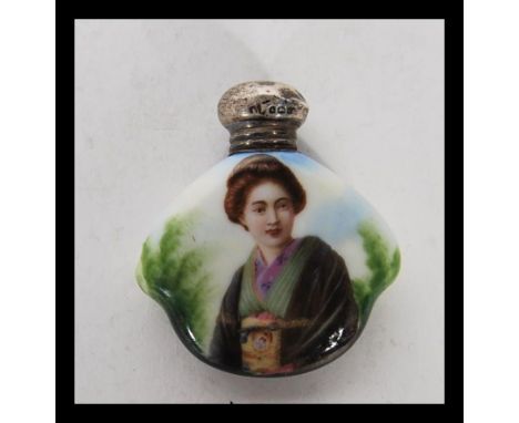 A early 20th Century ceramic perfume bottle having Gashua girl to front and silver hallmarked screw top. Hallmarked for Birmi