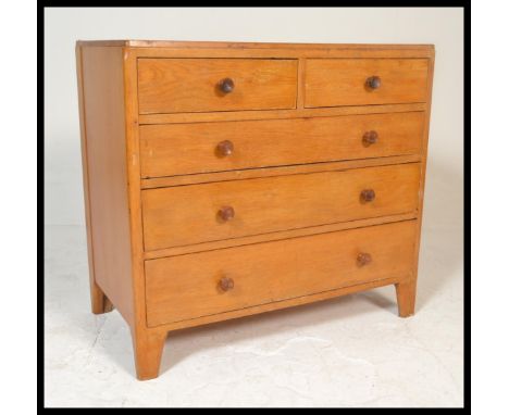 A 20th Century 1962 light oak 'utility' chest of drawers in the manner of Heal's, with two short over three long drawers, rai