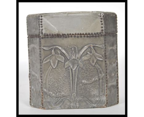 A late 19th century Arts and Crafts hammered pewter bound octagonal wooden tea caddy with hinged&nbsp;lead and floral decorat