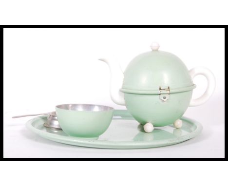 An early 20th Century circa 1930's miniature Heatmaster tea service for one. The service consisting of teapot, cup, tea strai