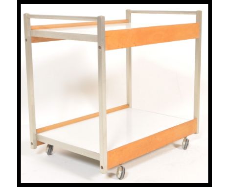 A retro mid 20th Century two tier drinks / buffet trolley. The trolley raised on a aluminum tubular frame with beech flashes 