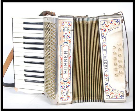 A 20th Century Hohner Student ll (2) piano accordion, having its original leather strap and original paint work, stamped to b