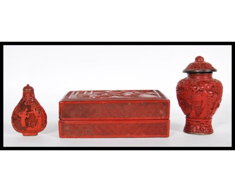 Three Chinese red cinnabar lacquer items to include, snuff bottle and stopper decorated with oriental scenes having character