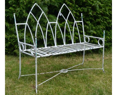 An early 20th Century Gothic revival cast iron garden bench, the bench having a twin arch gothic form design, open back backr