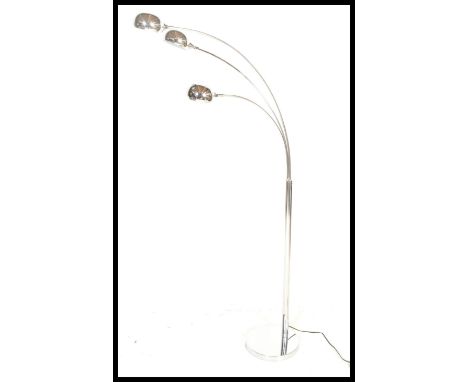 A vintage style atomic three point chrome floor lamp, circular base with chrome tubular upright having three adjustable suspe