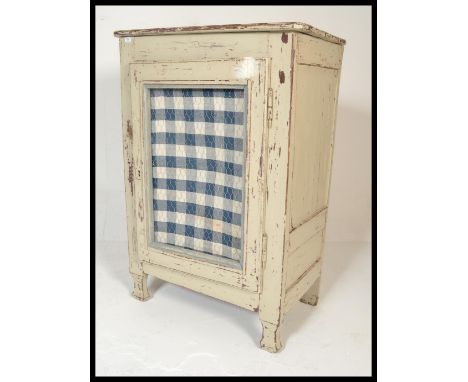 An early 20th century country house large painted white pine meat safe locker. The cupboard of large form with mesh panel to 