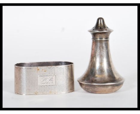 A silver hallmarked pepperette of curved tapering form with pierced lid to top (hallmarked Birmingham 1943) together with a s