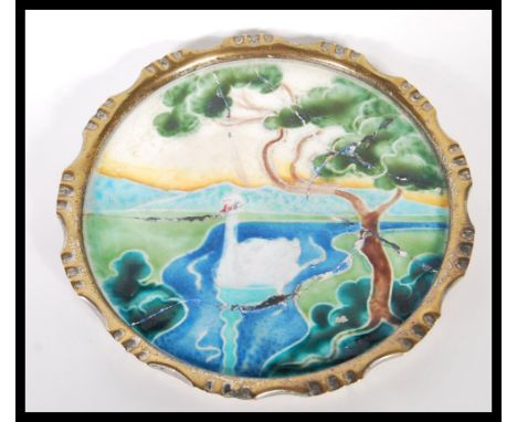 A late 19th/ early 20th Century Art Nouveau ceramic card / pin tray, having an enamelled scene of a swan along a river, with 