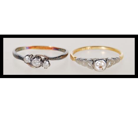 A hallmarked solitaire diamond 18ct gold platinum ring&nbsp; together with another 18ct gold and platinum mounted with three 