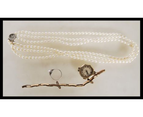 A small group of vintage jewellery to include, a three string cultured pearl necklace having silver clasp stamped 925 and a s