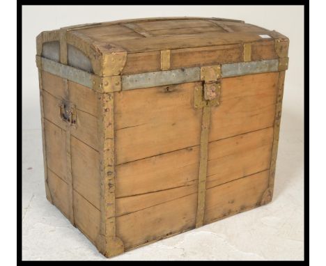 A 19th Century Victorian wooden bound dome top travel trunk,, hinged top with latches to the front, carry handles to side.&nb