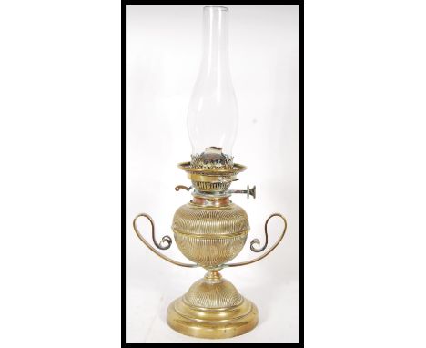 A vintage early 20th Century brass oil lamp titled ' The Hicks No2 ', the brass lamp of bulbous form with twin scrolled handl