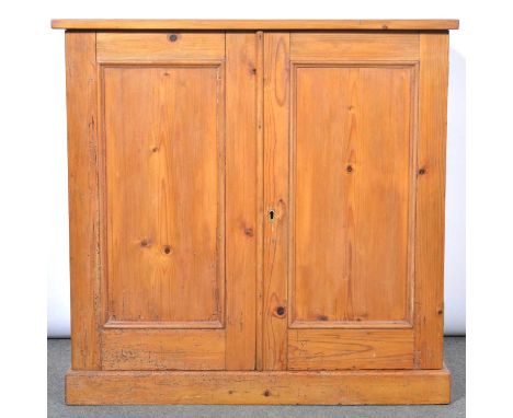 Pine cupboard, rectangular top, two panelled doors enclosing a shelf, plinth base, width 83cm, depth 48cm, height 81cm.