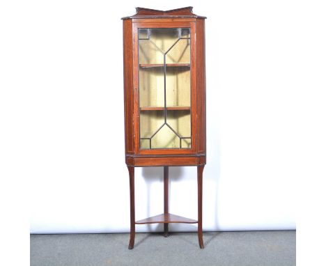 Edwardian mahogany display cabinet, shallow pediment, glazed door enclosing two shelves, splayed legs joined by an open shelf