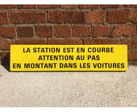 Original French railway station enamel sign 'La Station est en courbe attention au pas en montant dans les voitures', yellow 