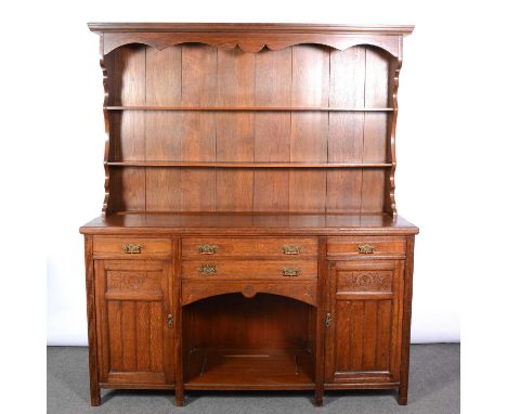 Edwardian oak dresser, moulded cornice, panelled back with two fixed shelves, the base with moulded edge, four drawers above 