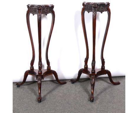 Pair of mahogany tripod torcheres, triangular tops with pierced frieze, carved splayed legs joined by a shelf, height 87cm.