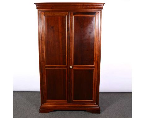 Modern mahogany double wardrobe, moulded cornice, two panelled doors enclosing a shelf and hanging rail, bracket feet, width 