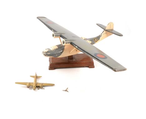 A scratch built Catalina, on stand; a brass airplane; and a print of a Catalina. The scratch built plane was built by Fred Go