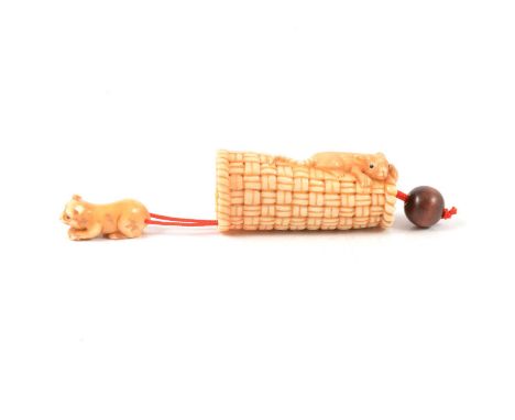 Japanese carved ivory novelty netsuke of cat and mouse on a basket, early 20th century, heightened with staining, the cat car